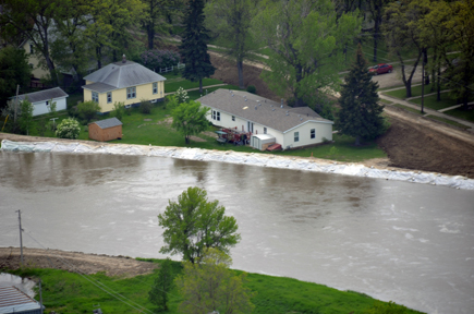 Water reaching top of levee crest.